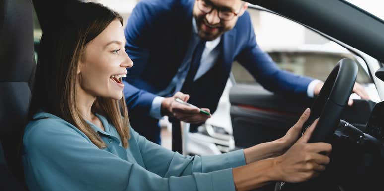 Woman buying a car from a car dealership