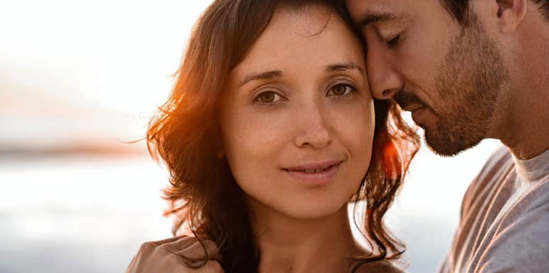 Husband nuzzling stressed out, burned out wife 