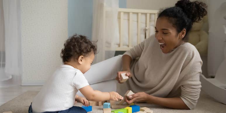 nanny playing blocks with toddler