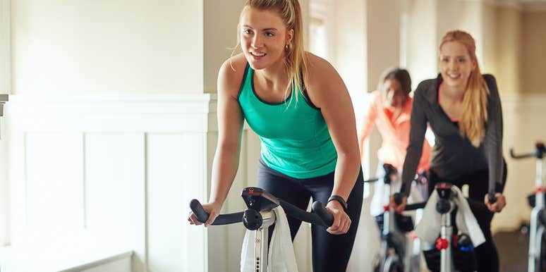 group of women using exercise bikes