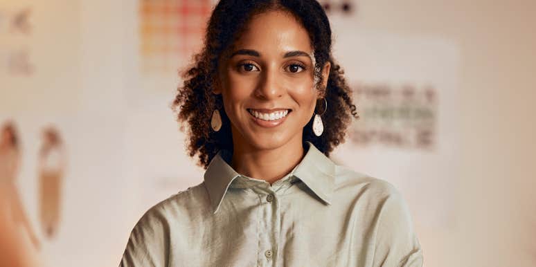 Confident woman smiling in an office.