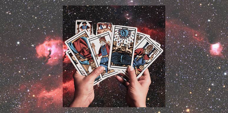 hands holding tarot cards for monthly horoscope january 2025