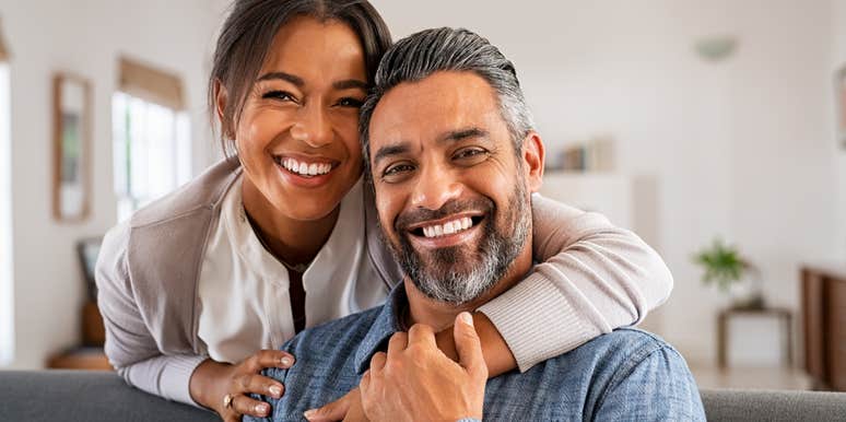 couple smiling together sitting on couch