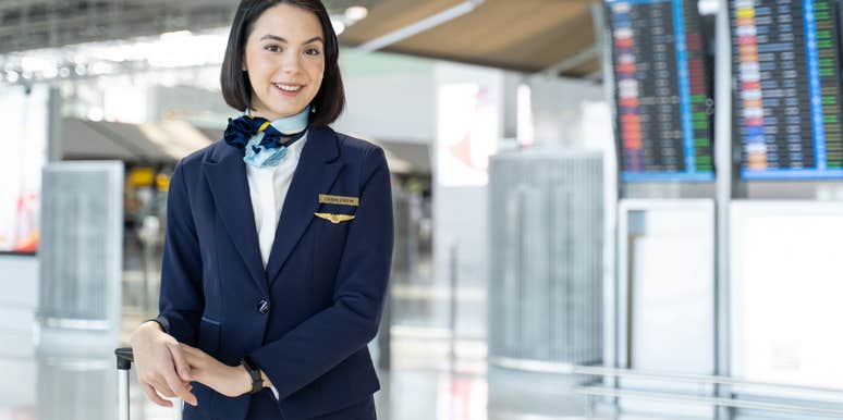 Portrait of Caucasian flight attendant standing in airport terminal