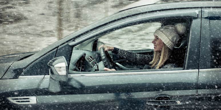 Woman driving through a blizzard to get to work