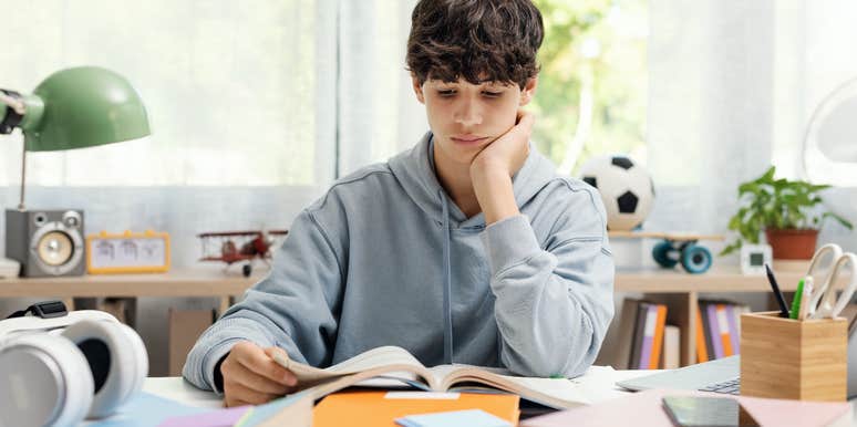 Teen boy reading a book