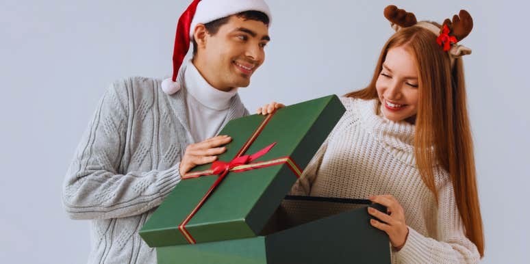 woman opening husband's christmas gift 