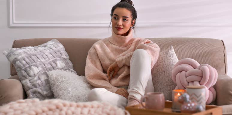 Woman sitting on her cozy couch in her living room