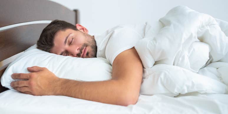 Man sleeping in his bed at home