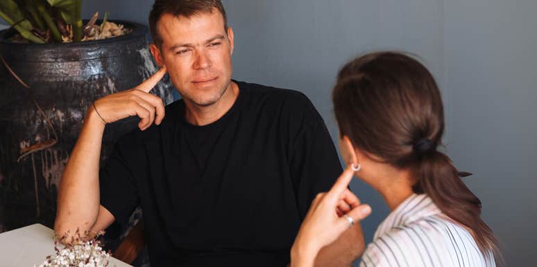 Man being scared away by woman.