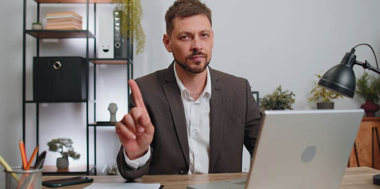 businessman sitting at desk saying no