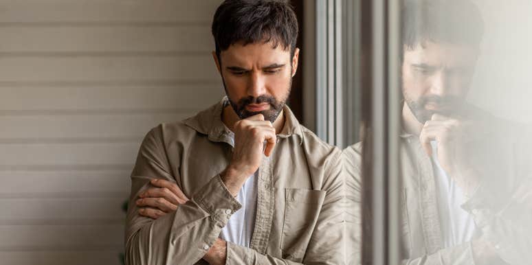 Millennial looking down feeling inferior because he doesn't own a home