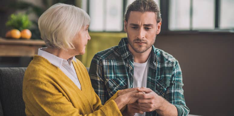 mom holding son's hands during serious conversation