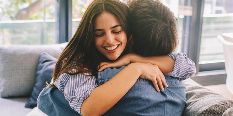 loving woman warmly embracing her husband