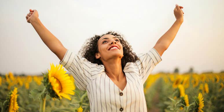 Woman standing in sunflower field