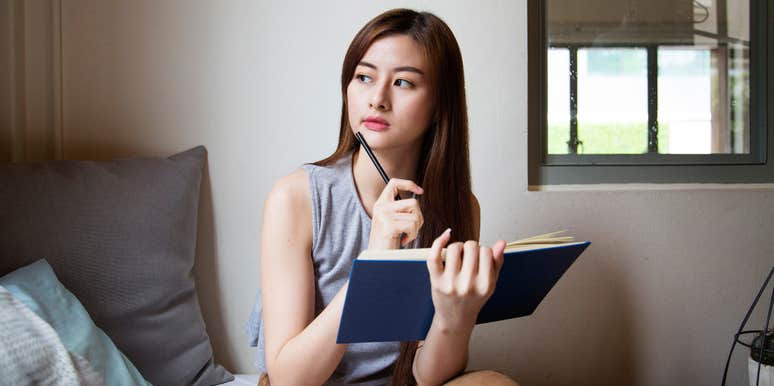 Woman writing New Year's Resolutions