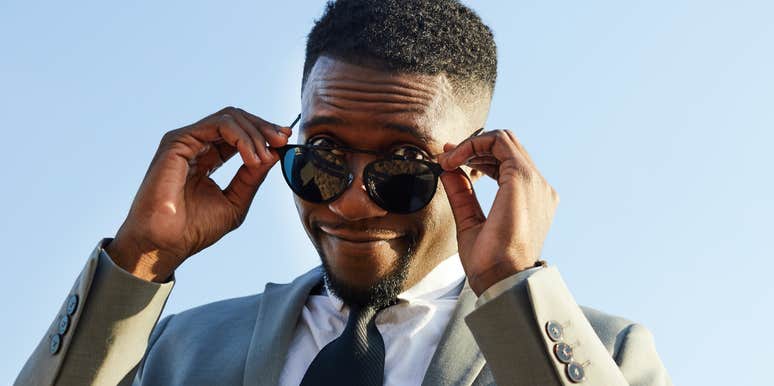 Handsome Black man on the rebound, looking over his glasses