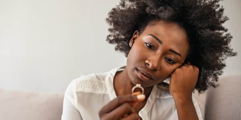 miserable wife looking at her wedding ring