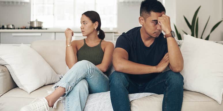 miserable married couple sitting side by side