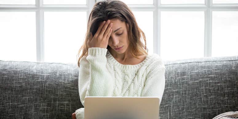 upset student looking at PhD program rejection on laptop