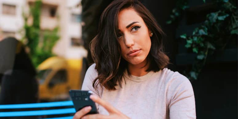 Woman looking dubious because texts causing her relationship to fall apart