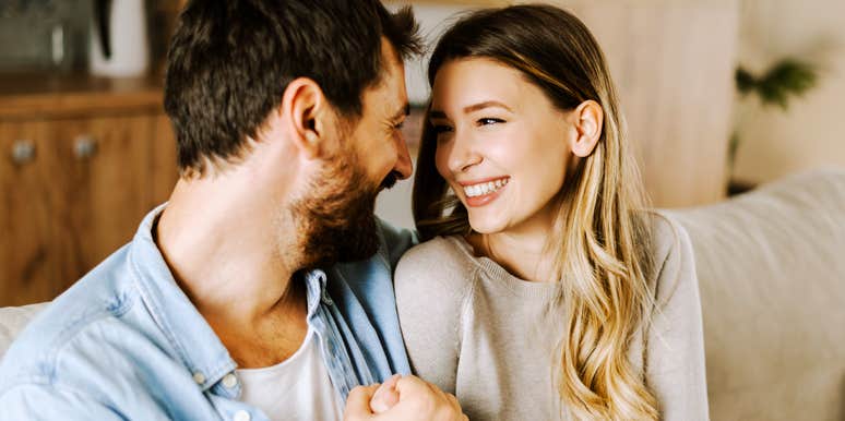 Couple communicating with each other on couch. 