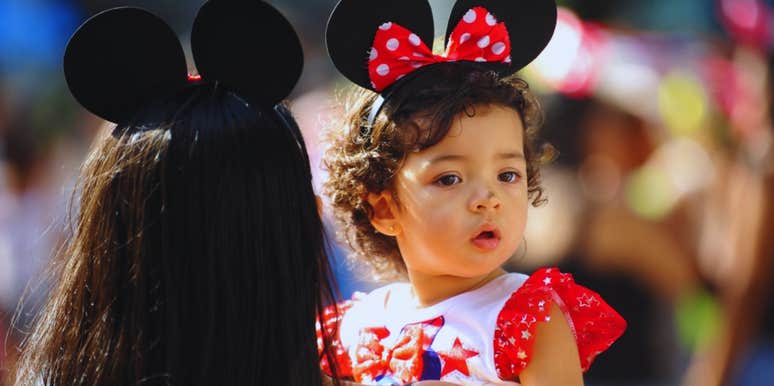 mom holding daughter at disney