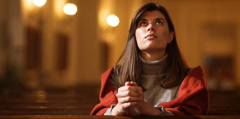 Parent sitting in the aisle seat of a church pew