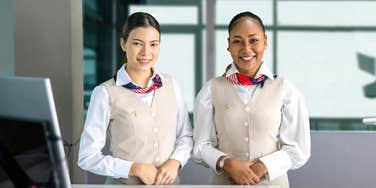 flight attendants posing with smile at the check in counter
