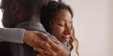Close up young black wife embracing husband
