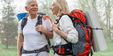 Older couple working out together on a hike. 