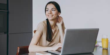 Happy woman working on computer