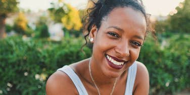 smiling woman following golden rules of happiness