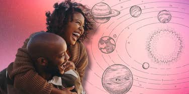 happy couple looking at orbiting planets