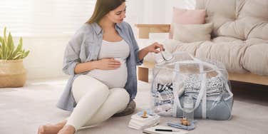 pregnant woman packing for her hospital stay