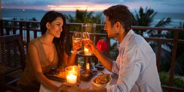 couple on a romantic candlelit date outside during sunset