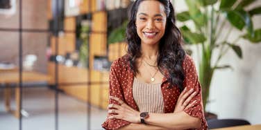 woman crossing arms while smiling