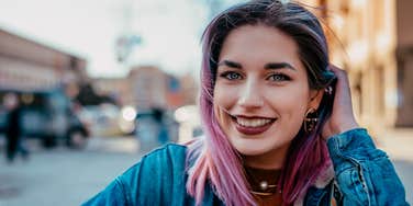 dignified and respectable woman with pink hair smiling