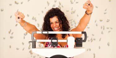 Woman using rice, to aid her weight loss