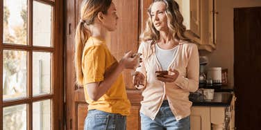 mom and teen daughter in kitchen