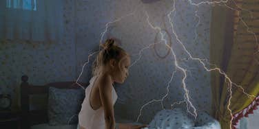 Young girl in her room during a severe weather event 