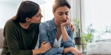 Woman comforting someone she loves who is overwhelmed