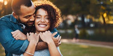 Sociopathic man hugging woman from behind