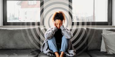 Woman fatigued with a headache, stuck in low vibrational pattern