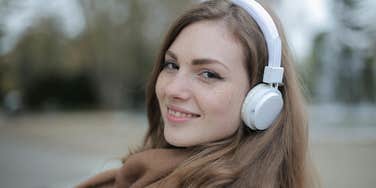 Smiling woman alone with headphones