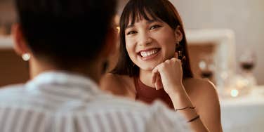 Woman smiling during a first date. 