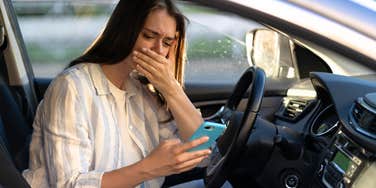 Woman crying after receiving text from husband, now former husband.