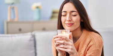 American woman smelling a candle