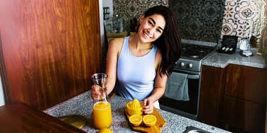 Healthy woman juicing 