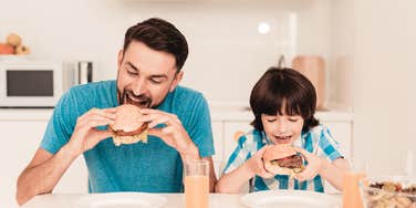 Husband eating meat with his kid